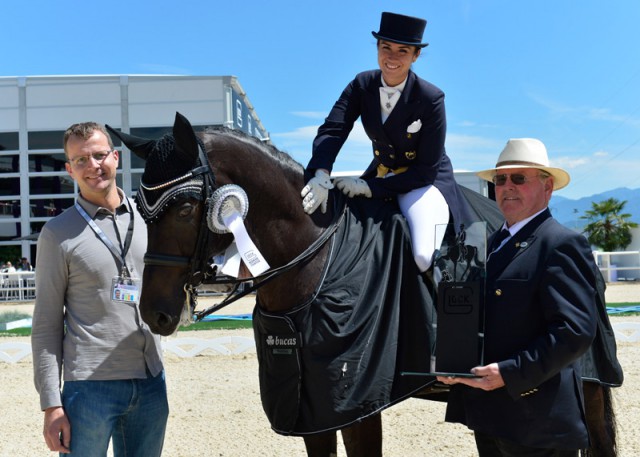 Isabelle Steidle (GER), seated on Long Drink, accepted the GLOCK winner’s trophy in the CDI3* Grand Prix de Dressage. Franz-Peter Bockholt (Show Director) offered his congratulations. © GHPC / studiohorst