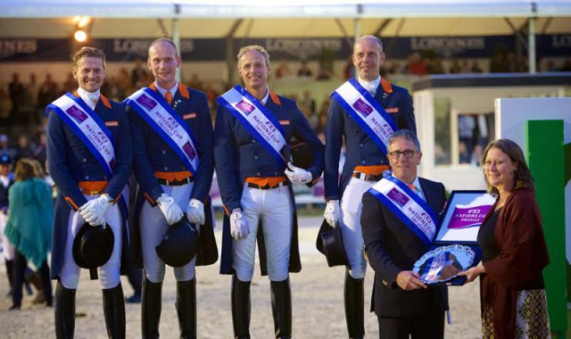 The Dutch team celebrate victory in the third leg of the FEI Nations Cup™ Dressage 2015 pilot series in Rotterdam, The Netherlands (L to R): Edward Gal, Diederik van Silfhout, Patrick van der Meer and Hans Peter Minderhoud. Dutch Chef d’Equipe, Wim Ernes, accepts the trophy from Show President, Belle de Bruin. © FEI/Arnd Bronkhorst