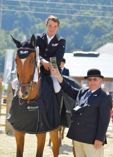 Conor Drain (IRL) received the GLOCK’s winner’s trophy in the CSI2* opening from Franz-Peter Bockholt (Sports Director GHPC). © GHPC / studiohorst
