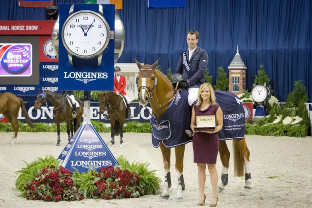 Harrie Smolders (NED) and Emerald (left), winners of the Longines FEI World Cup™ Jumping at the Washington International Horse Show, were presented with a Longines watch by Taylor Mace, National Event Manager for Longines. © StockImageServices.com/FEI
