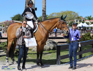 Ali Wolff, Artemis and groom Stacy Lawless are presented with the “Best Presented Horse” Award and a Dy'on halter and lead shank by Elena Couttenye of Equis Boutique during Week 5 at the Winter Equestrian Festival. © Jump Media