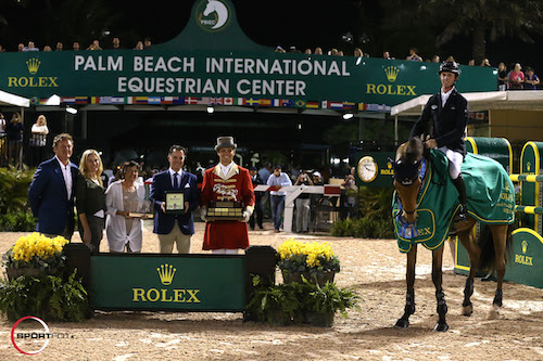 Ben Maher and Sarena in their winning presentation with Equestrian Sport Productions CEO Mark Bellissimo; Wellington Equestrian Partners Principal Katherine Bellissimo; Wellington Equestrian Partners' Marsha Dammerman; Joël Aeschlimann, Head of Sponsorship, Rolex; and ringmaster Christian Craig. © Sportfot