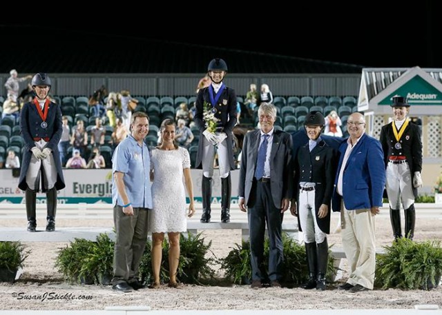Laura Graves (USA), Kasey Perry-Glass (USA), and Belinda Trussell (CAN), stand in their presentation ceremony with Allyn Mann of Adequan®, Cora Causemann of AGDF, judge Thomas Lang (AUT), Arlene "Tuny" Page of Stillpoint Farm, and Michael Stone of Equestrian Sport Productions. © Susan J. Stickle