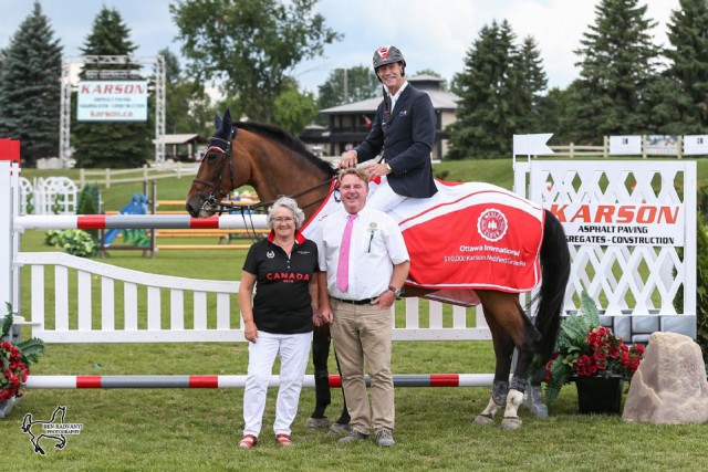 Ian Millar is presented as the winner of the $10,000 Karson Modified Grand Prix by Ann Matthews and Tony Dunn, Chief Operating Officer of Wesley Clover Parks. © Ben Radvanyi Photography