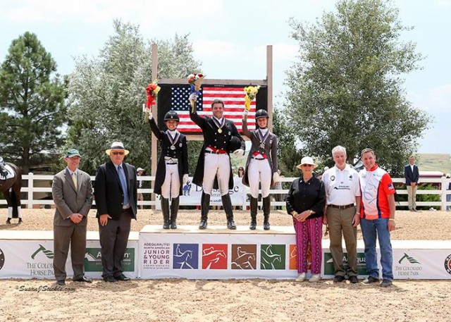 Nicholas Hansen tops the podium in the USDF Junior & Young Rider Dressage Championships Young Rider Individual Test with Rachel Robinson and Lexy Donaldson, alongside Bill Moroney, Chief Executive Officer of USEF; Michael Stone, President of The Colorado Horse Park; Jennie Loriston-Clarke, Foreign Technical Delegate; Steve Hienzsch, Executive Director of USDF; and Allyn Mann of Adequan®. © Susan J Stickle 