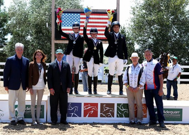 Jenna Upchurch, Vanessa Creech-Terauds, and Carlos Maldonado Lara in their medal presentation ceremony with Stephan Hienzsch, Executive Director of USDF; Meg Krueger, COO of The Colorado Horse Park; Bill Moroney, CEO of USEF; Jennie Loriston Clarke, Foreign Technical Delegate; and Allyn Mann of Adequan®. © Susan Stickle
