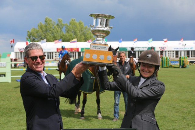  Tom Heathcott presents Lucy Deslauriers with her winning trophy. © Spruce Meadows Media Services