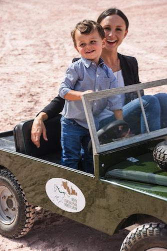 Georgina Bloomberg and her son Jasper in a mini Land Rover vehicle © Meg Banks