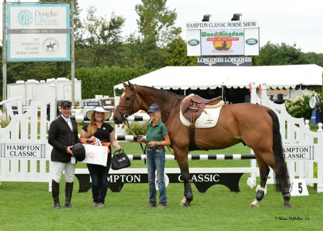 Peter Leone, Capito Z, and groom Valerie Huckstepp are presented with a KASK Helmet by Alex West (center) of Equis Boutique after winning the Equis Best Presented Horse Award at the Hampton Classic Horse Show. Photo by Shawn McMillen Photography