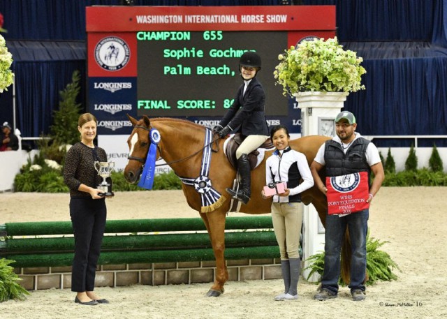 Storyteller and Sophie Gochman in their winning presentation for the WIHS Pony Equitation Finals with WIHS Executive Director Bridget Love Meehan, 2015 winner Mimi Gochman, and groom Luis Armbello. © Shawn McMillen Photography