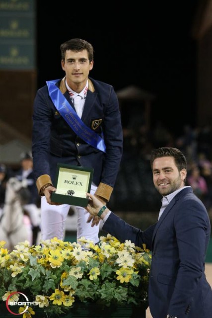 Nicola Philippaerts is presented with a Rolex watch from Kyle Younghans of Rolex at the conclusion of the $380,000 Rolex Grand Prix CSI 5* at TIEC. © Sportfot