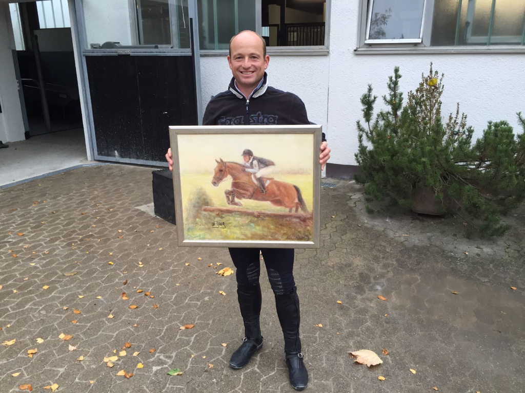 Olympiasieger Michael Jung mit dem zu ersteigernden Gemälde. © Privat