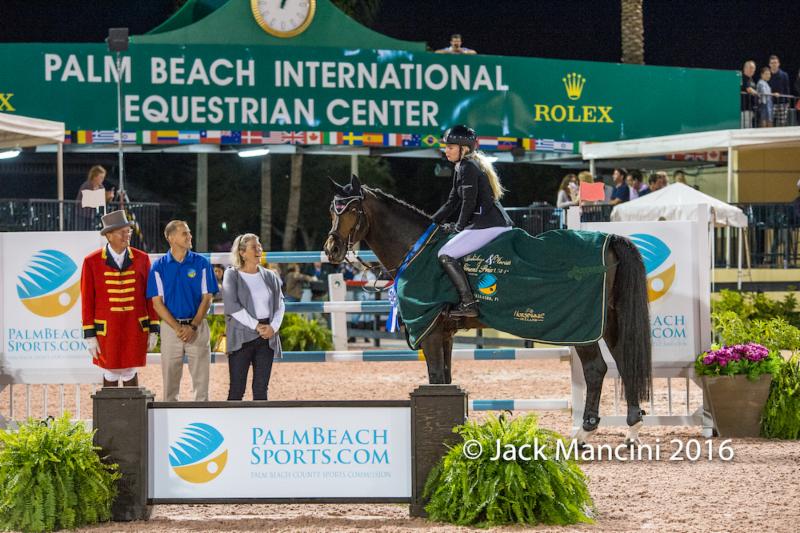 Liubov Kochetova and Balou Du Reventon in their presentation ceremony with ring master Steve Rector; Scott Glinski, Marketing & Communications Manager at Palm Beach County Sports Commission, and Lisa Lourie; partner of the Wellington Equestrian Partners (WEP). © ManciniPhotos