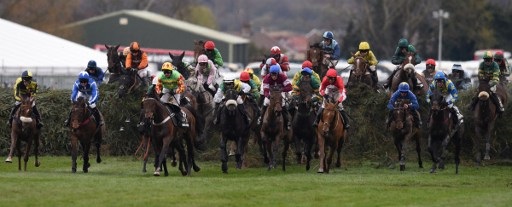 Riders compete in The Grand National Steeple Chase on the final day of the Grand National Festival horse race meeting at Aintree Racecourse in Liverpool, northern England on April 9, 2016. The annual three day meeting culminates in the Grand National which is run over a distance of four miles and four furlongs (7,242 metres), and is the biggest betting race in the United Kingdom. / AFP PHOTO / OLI SCARFF