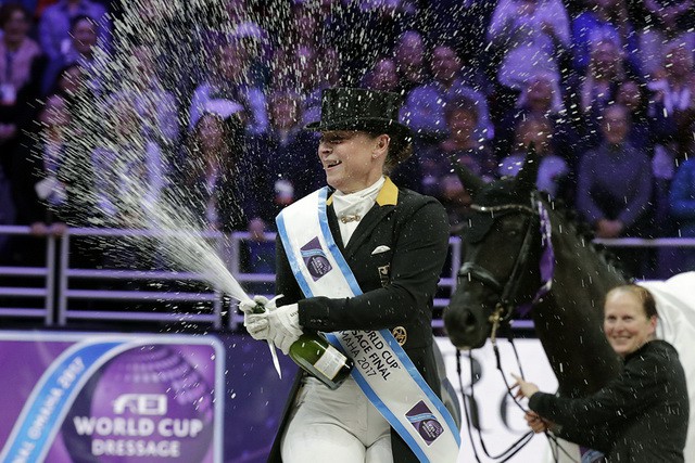 Jubilation on the podium as Isabell Werth celebrates her win watched by her groom Steffi Weigard and her beautiful mare Weihegold at the FEI World Cup™ Dressage Final 2017 in Omaha (USA). © Jim Hollander/FEI